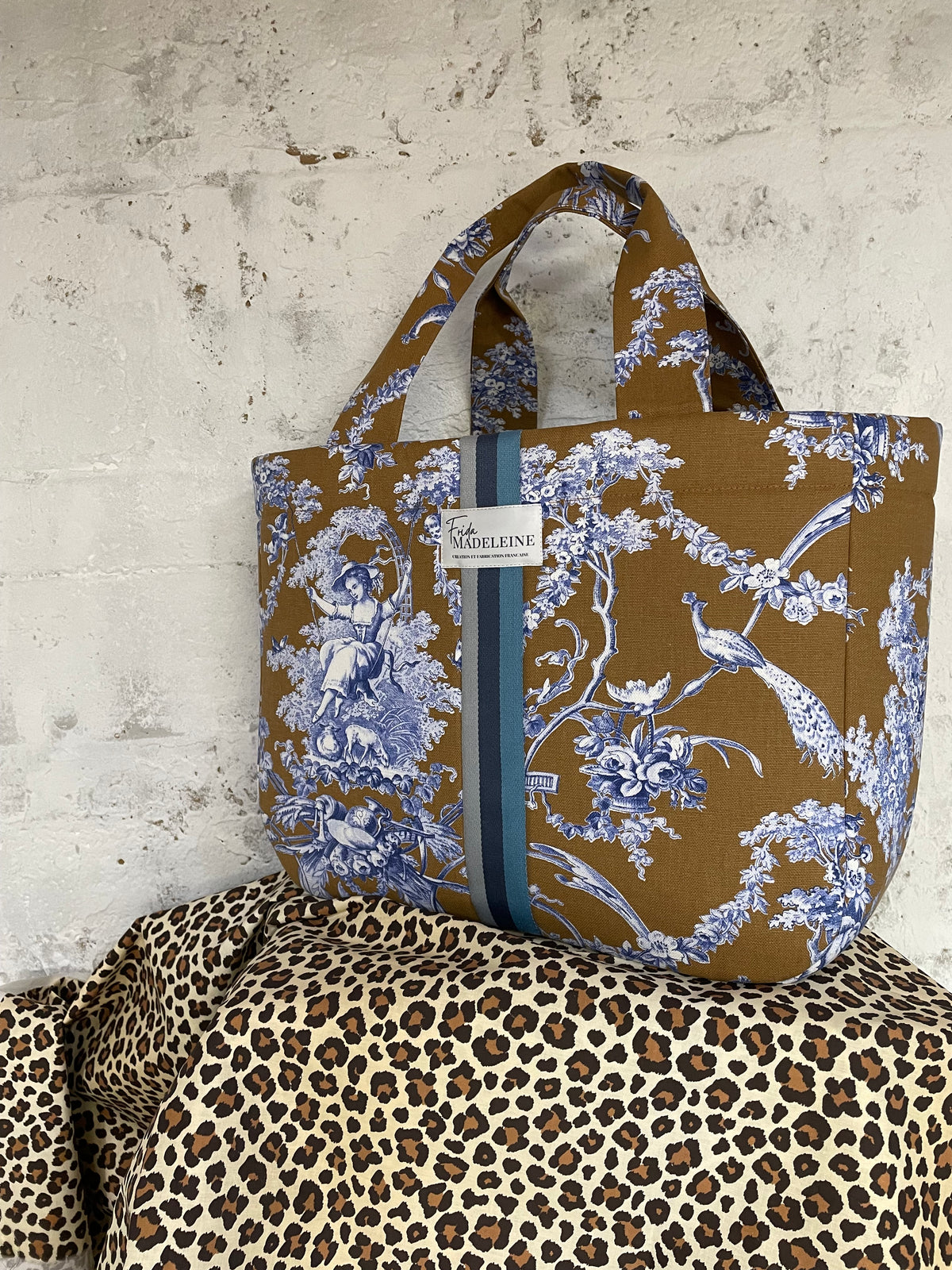Gros plan sur les motifs pastoraux bleus et camel de la Toile de Jouy haut de gamme